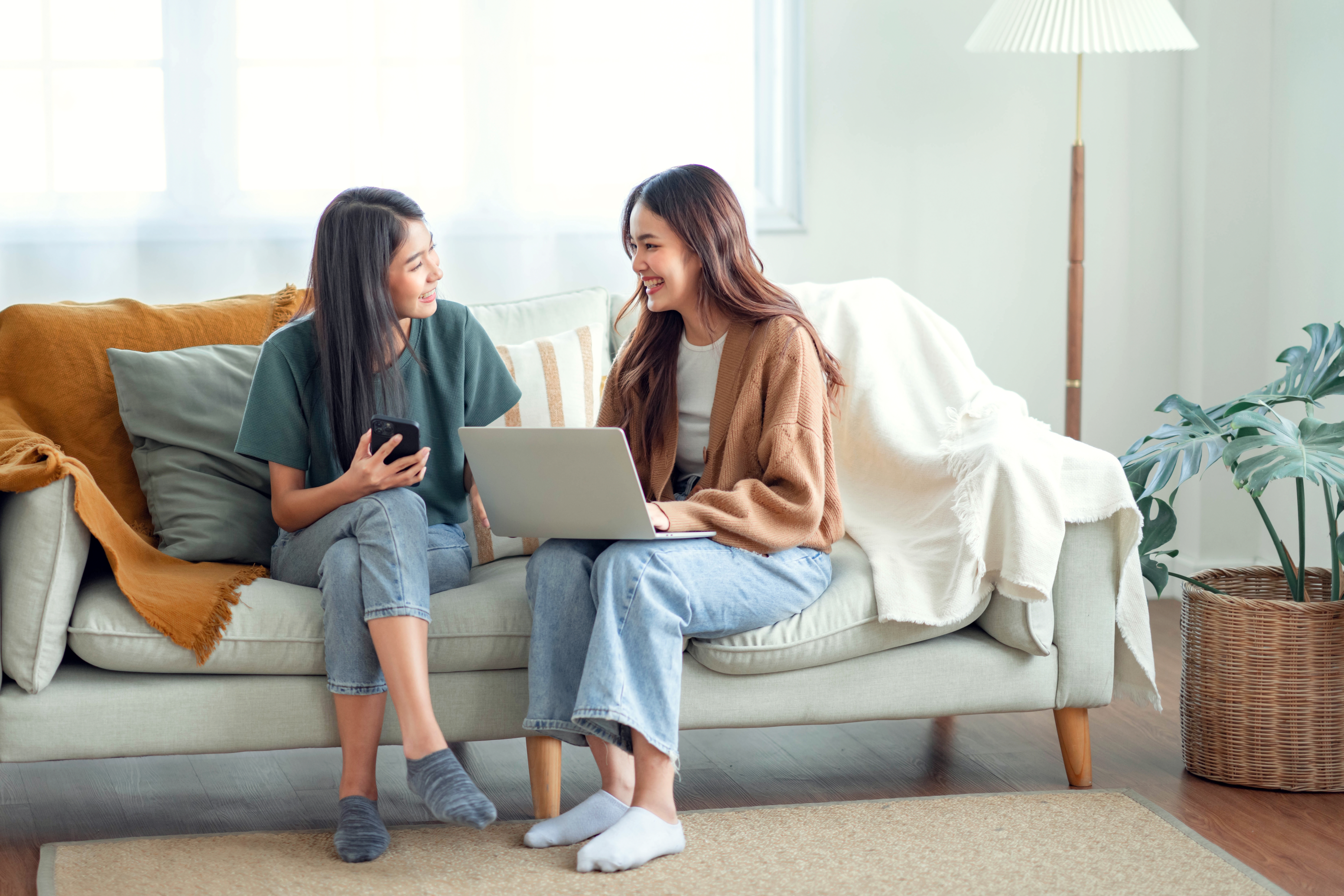 Women connecting with classmates through technology